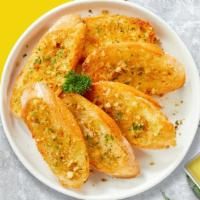 Gustavo Garlic Bread · Toasted homemade bread baked with garlic butter, and parsley.