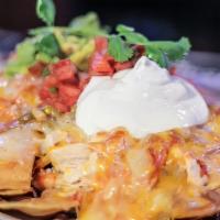 Nachos Especiál · Choice of shredded chicken or shredded beef, topped with salsa ranchera, melted cheese, sour...