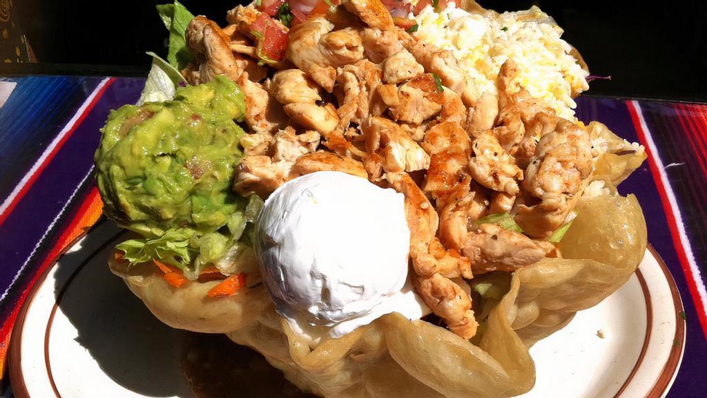 Grande Taco Salad · A flaky flour tortilla shell filled with lettuce, beans and your choice of shredded chicken or beef or grilled chicken. Topped with pico de gallo, cheese, guacamole and sour cream.