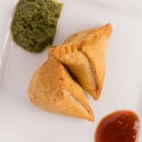 Samosa · Crispy pastry filled with mildly potatoes and peas.