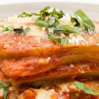 Eggplant Parmigiana · Layers of grilled eggplant, tomato sauce, and shredded mozzarella, topped with Parmesan chee...