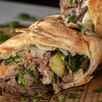 Beef Shawarma Wrap · Thinly sliced Top Sirloin marinated for 4 days - cooked a-la-minute, Parsley, Tomato, Onions...