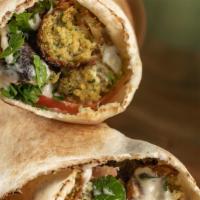 Vegan Falafel Wrap · Homemade Falafel made with dry garbanzo, fresh herbs and spices, Tomato, Pickled Turnips, Pa...
