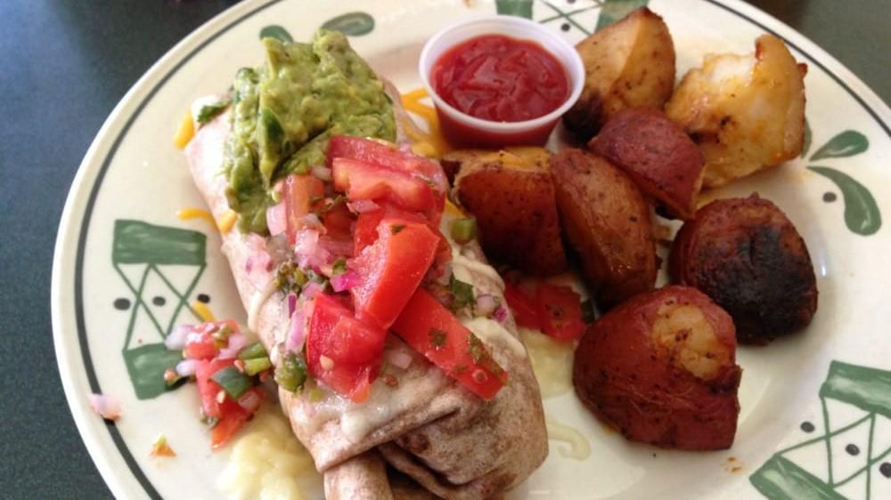 Breakfast Burrito · Three scrambled eggs with black beans, guacamole, pico de gallo, jack and cheddar cheese, and 
your choice of Mexican chorizo sausage, bacon or turkey bacon in a flour tortilla. Served with fresh fruit or roasted potatoes.