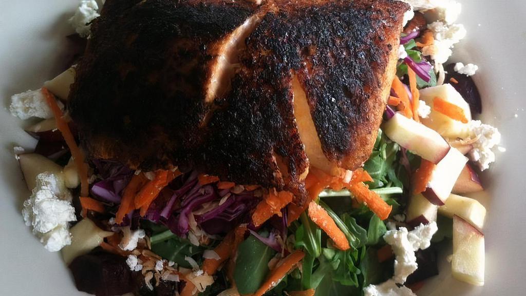 Arugula Salmon Salad · Served with baby arugula, blackened salmon, goat cheese, red apples, roasted coconuts, beets, carrots, red cabbages, and caramelized walnuts. Served with dijon vinaigrette.