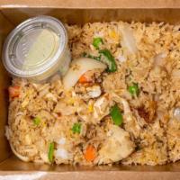 Thai Fried Rice · Jasmine rice stir-fried with eggs, white onions, green onions, peas and carrots.