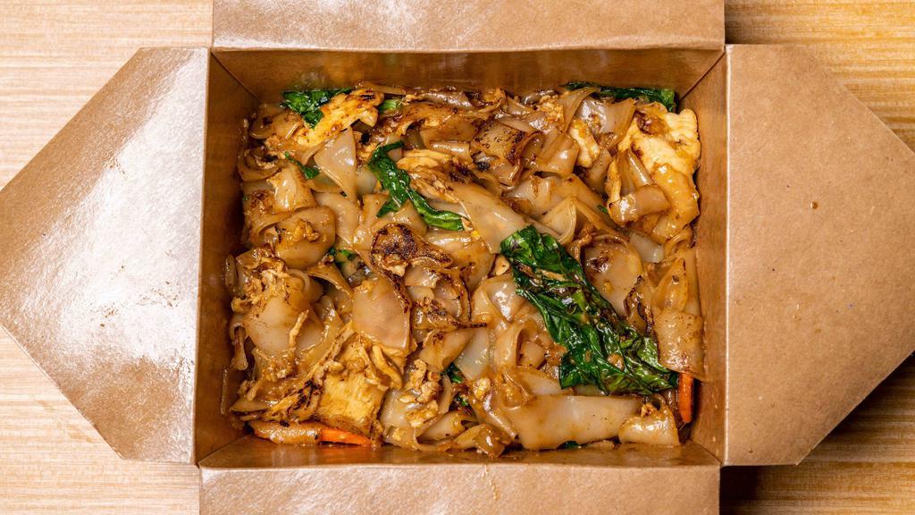 Pad See Ew · Large flat rice noodles stir-fried with eggs, carrots, and Chinese broccoli.
