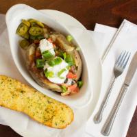 Mexican Stuffed Baked Potato · Chili, cheese, olives, tomatoes, jalapenos, and onions.