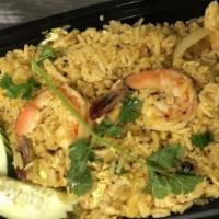 Pineapple Fried Rice · Fried rice with shrimp chicken pineapple cashew nut onions raisin and egg. seasoned with cur...