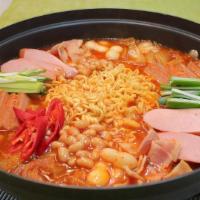 Budae Jjigae · Army stew - aged kimchi and spicy sausage stew with tofu and vegetables. Served with choice ...