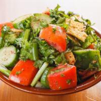Fattoush · A Lebanese salad with crushed toast bread, parsley, tomato, bell pepper, cucumber and green ...