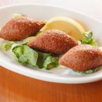 Kibbeh · Lean beef mixed with crushed wheat and stuffed with seasoned ground beef and pine nuts.