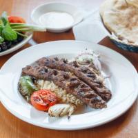 Kafta Kabab (Luleh Kabab) · Ground kabab spiced and char-broiled. Served with rice, barbecued tomato and onion.