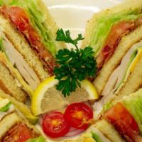 Turkey Club Sandwich · Turkey, bacon, avocado, lettuce, tomato, your choice of cheese and a side of potato salad