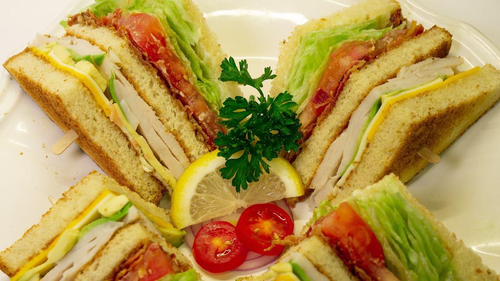 Turkey Club Sandwich · Turkey, bacon, avocado, lettuce, tomato, your choice of cheese and a side of potato salad