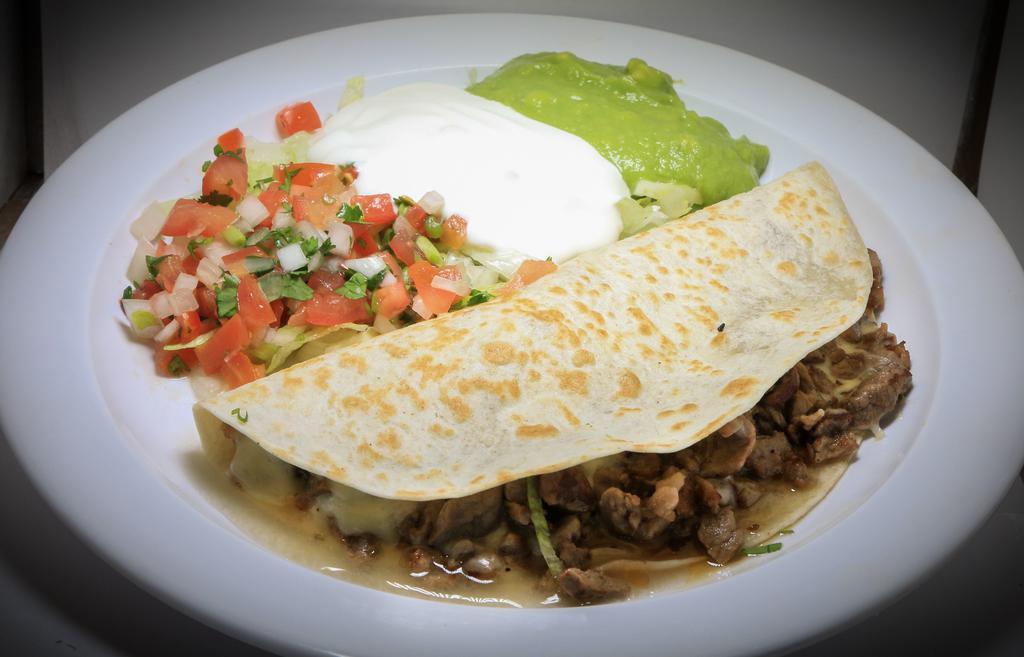 Super Quesadilla · Cheese and choice of meat with lettuce, guacamole, sour cream, and tomatoes.
