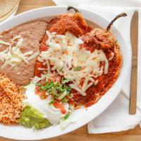Plato De Chile Rellenos · Served with refried beans, rice, and salad