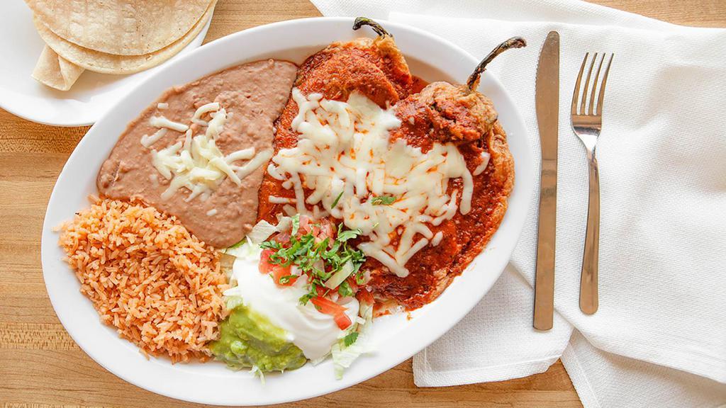 Plato De Chile Rellenos · Served with refried beans, rice, and salad