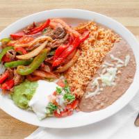 Fajitas · Served with refried beans, rice, salad, and tortillas.
