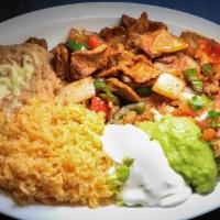Steak Ranchero · Served with refried beans, rice, salad, and tortillas.