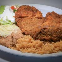 Plato De Milanesa · Breaded carne asada. Served with refried beans, rice, salad, and tortillas.