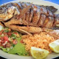 Mojarra Frita · Fried mojarra. Served with refried beans, rice, salad, and tortillas.