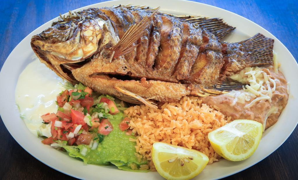 Mojarra Frita · Fried mojarra. Served with refried beans, rice, salad, and tortillas.