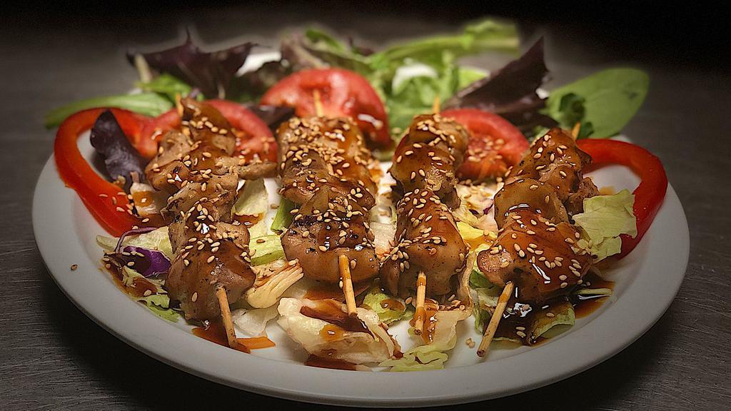 Teriyaki Chicken · Skewers of chicken meat seasoned with teriyaki sauce and sesame seed. 
Served with sort of salads + cucumber or tomatoes