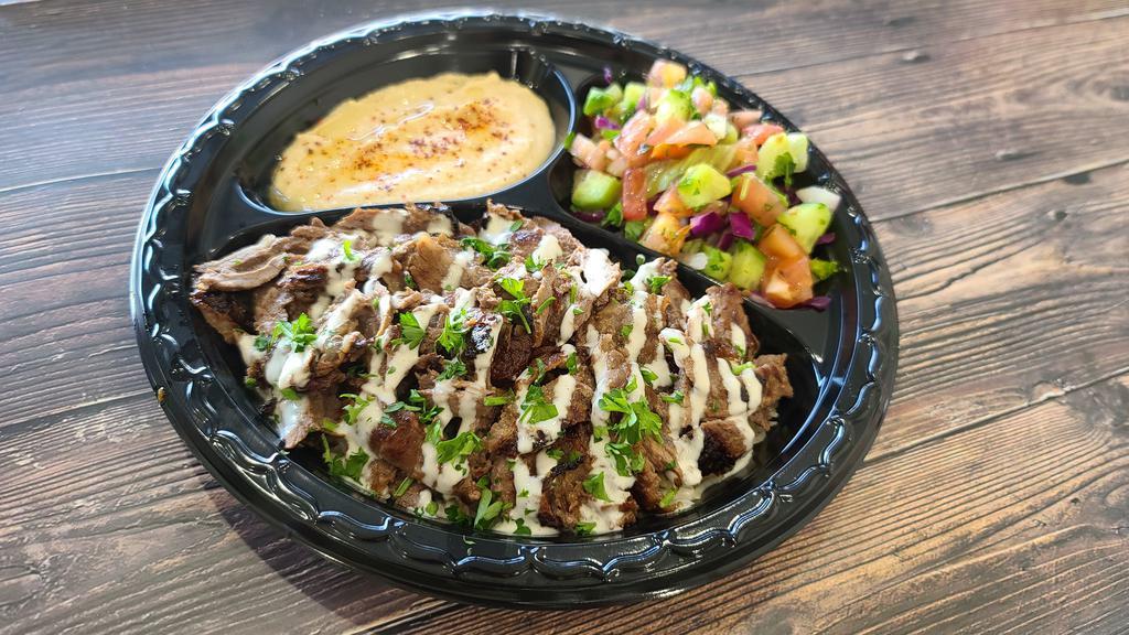 #10 Beef Shawarma Plate · Comes with grilled tomato, spicy pepper, salad, rice,
choice of side of hummus or baba ganoush, a choice of dipping sauce and special home made bread.
Sauce will be on the top(tahini), if you like sauce to be on the side, please let us know!