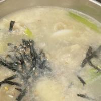 Dumpling Soup (만두국) · Dumpling soup. (Includes seasonal side dishes per order)