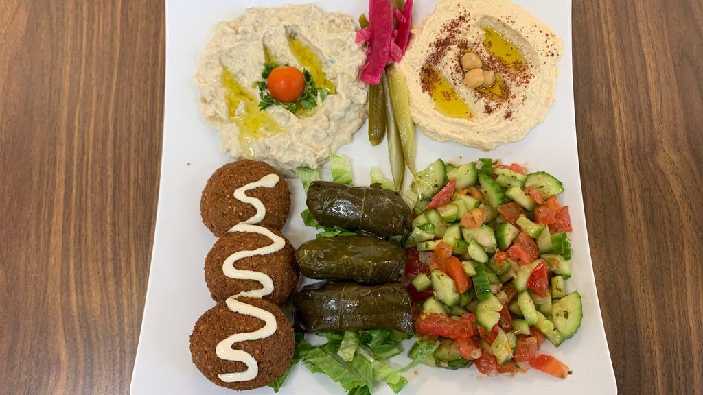Veggie Plate · The Veggie plate comes with baba ghanoush, hummus, salad, pita bread, 3 grape leaves, and 3 falafel