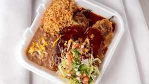 Two Chiles Rellenos Plate · 2 chile rellenos topped with red salsa and cheese, lettuce, guacamole and sour cream on side...