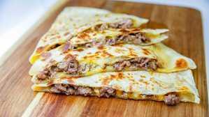 Ground Beef Quesadilla · meat and cheese quesadilla served with guacamole and sour cream on the side