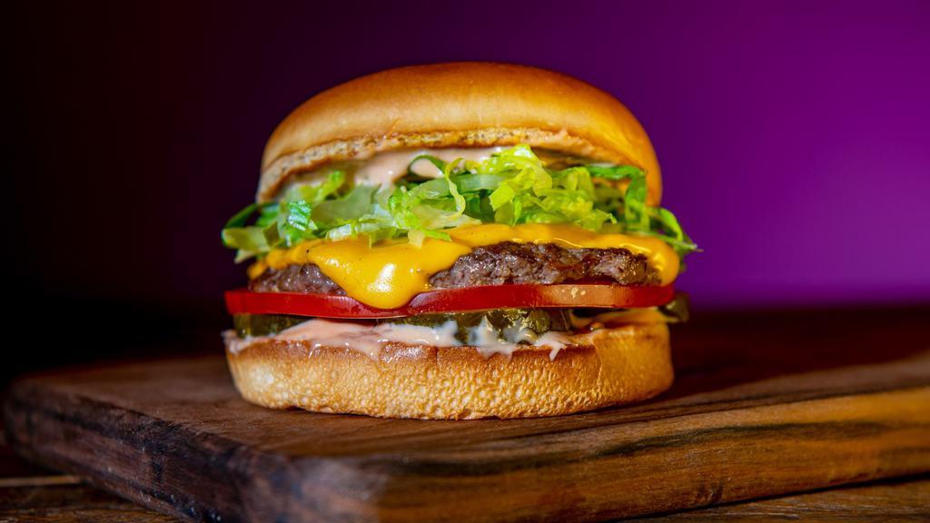 Signature Single Burger · Single 4 oz. Beef Patty, American Cheese, Classic Sauce, Pickles, Grilled Onions, Tomato, Lettuce.