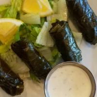 Dolmas · Stuffed grape leaves with rice, herbs, lemon and olive oil.