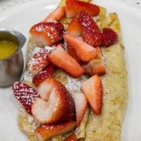 Fresh French Strawberry Crepes · Crepes are wrapped around fresh juicy strawberries, topped with tropical sauce, more strawbe...