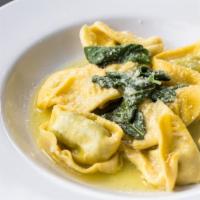 Caramelle Vecchia Modena · Stuffed pasta with ricotta and soinach, served in a light cream sauce with crispy bacon fini...