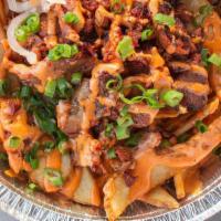 Bite Mi Fries · golden fries topped with grilled pork, house-made sauce & sriracha mayo