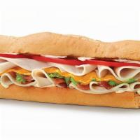 Ultimate Turkey Club Sandwich · Turkey, bacon, cheddar, lettuce, tomatoes, and mayonnaise with italian white bread.