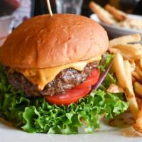 Brick Burger · ½ pound hand pressed ground chuck served on a toasted bun. Topped with American cheese, toma...