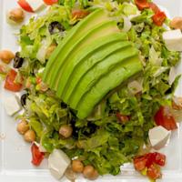 Chopped Salad · Chopped lettuce, garbanzo beans, tomatoes, avocado, mozzarella and olives tossed in a vinaig...