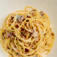 Spaghetti Carbonara · Spaghetti with crispy bacon and parmesan cheese in a light cream sauce