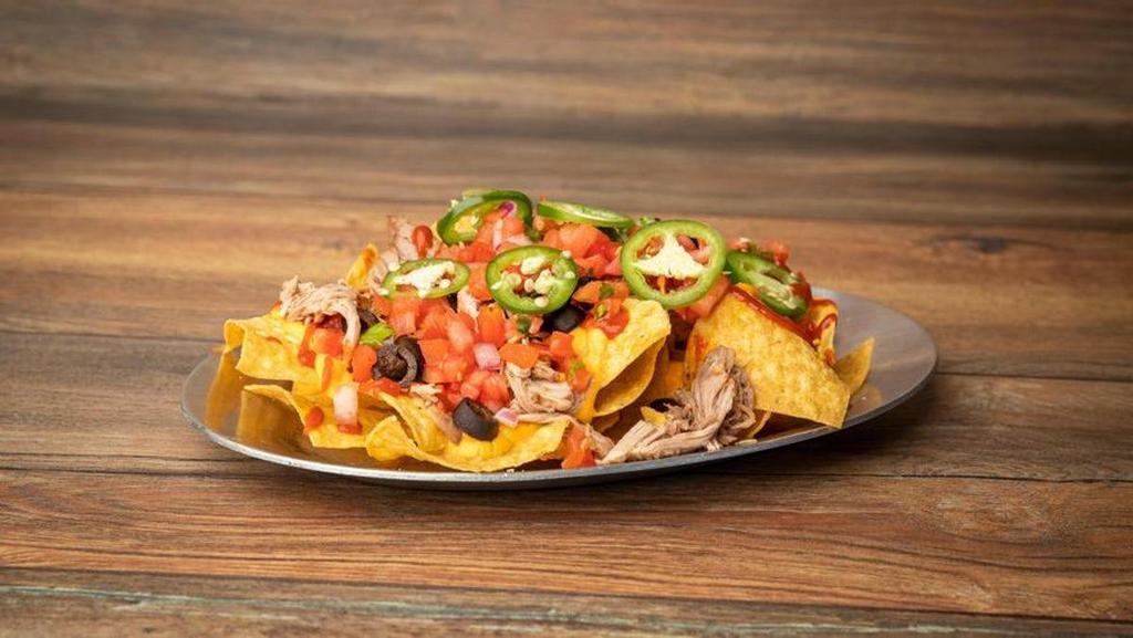 Nachos The Works · Crispy corn tortilla chips topped with nacho cheese, your choice of meat and any of our variety of toppings.