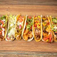 Taco Trio · Three (3) soft or hard shells stuffed with protein then filled to to the top with ingredient...