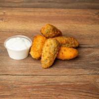 Jalapeno Poppers · Breaded, deep fried jalapeno poppers stuffed with cheddar cheese and served with a side of s...