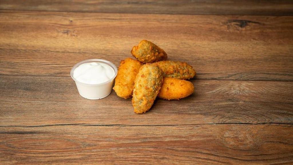 Jalapeno Poppers · Breaded, deep fried jalapeno poppers stuffed with cheddar cheese and served with a side of sour cream