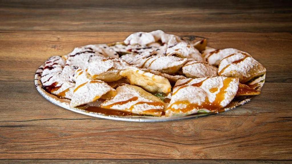 Love Chips · Flour tortillas dusted with powdered sugar and drizzled with raspberry or caramel sauce. We dare you not to fall in Love with this happy ending