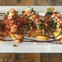Bruschetta · Tomatoes, Garlic, Herbs & Spices Served On Toasted Crostinis Drizzled with Balsamic Glaze Re...