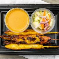 Chicken Satay · Marinated chicken skewers in a coconut milk and curry powder served with peanut sauce and cu...