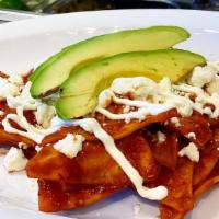Red Chilaquiles  · Handmade tortilla pieces cooked in red sauces and topped with queso fresco, sour cream, avoc...
